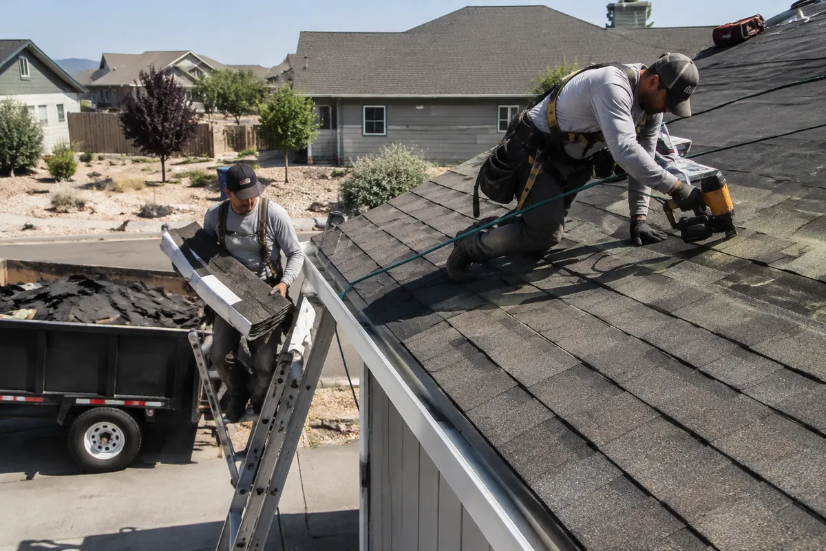 Roofing crew installing architectural asphalt shingles on a residential home in Boise, Idaho